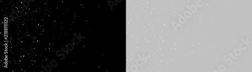 Obraz na plátně A scattering of white particles floats against a pitch-black background