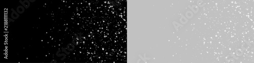 Obraz na płótnie Floating white particles create a scattered effect against a black background