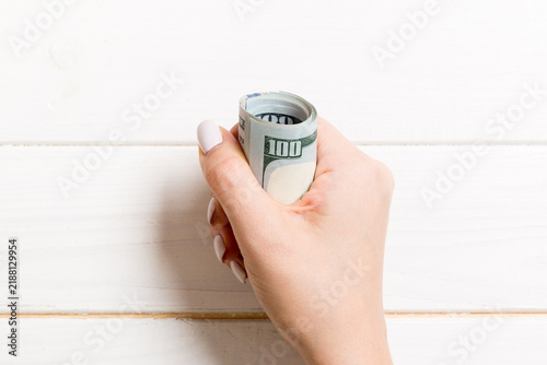 Fotografie Female hand holding tightly a bundle of money