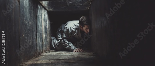 Obraz na płótnie Individual navigating a dark, confined space.