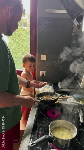 Father and child cooking at stove