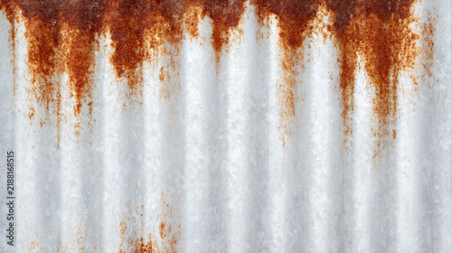 Rusty metal sheet with orange corrosion and white textured surface creating natural pattern