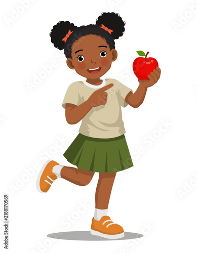 Little African girl holding red apple pointing index finger gesture isolated on white background
