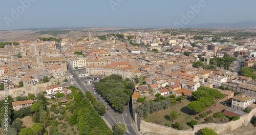 Panoramic view of the town of Tarquinia, in the province of Viterbo, in Lazio, Central Italy, with the trees of the public gardens, the medieval towers and the tiled rooftops of the old town.