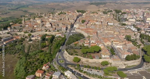 Panorama of the town of Tarquinia, in the province of Viterbo, in Lazio, Central Italy, with the road that runs around the historic center, the trees of the slope and the fields beyond.