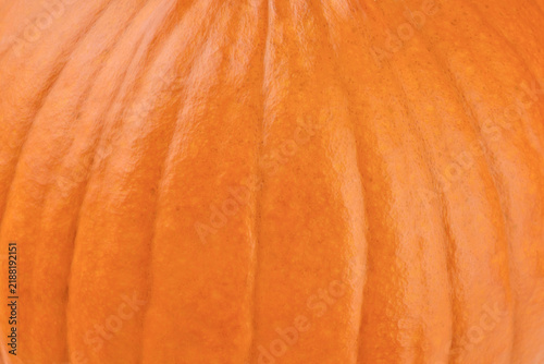 Close-up of orange pumpkin skin texture filling the frame