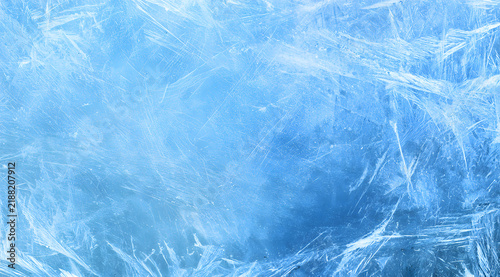 Background information on aged glass featuring a scratched and dusty effect, a worn texture in light blue and white frost patterns.