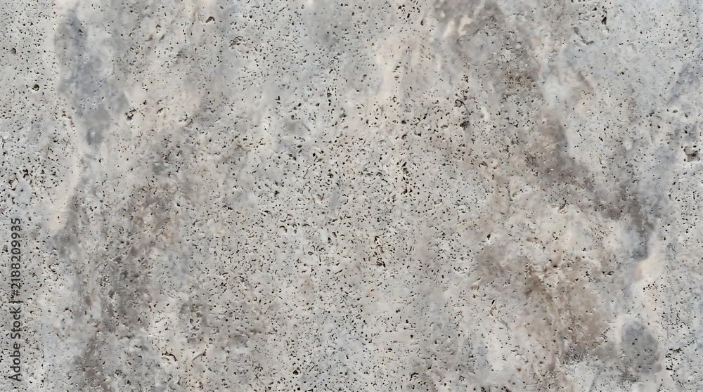 Fototapeta premium Close-up of weathered concrete surface with textured details in natural light