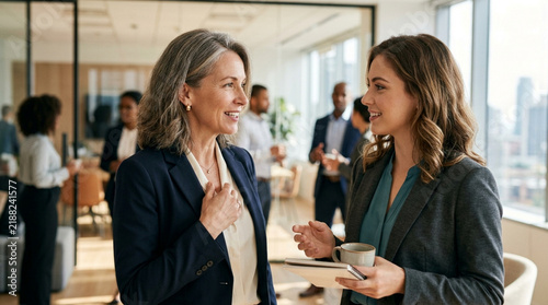Diverse colleagues in modern office discuss business, collaboration and mentorship