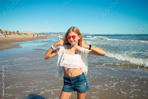 Children show different emotions while playing by the sea on a sunny day