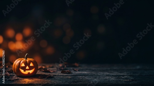 Dark minimal halloween background with subtle warm bokeh lights and dark rustic texture with copy space