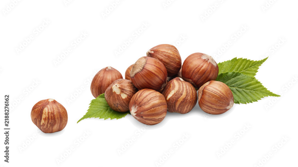 Fototapeta premium Whole hazelnuts with green leaves in natural studio lighting on a clean surface isolated on transparent background