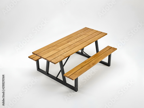 Wooden picnic table with metal legs isolated on a bright studio surface for outdoor dining concepts