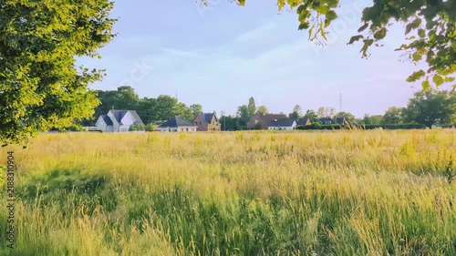 Autumn landscape in a European village shows fields and houses with trees in view