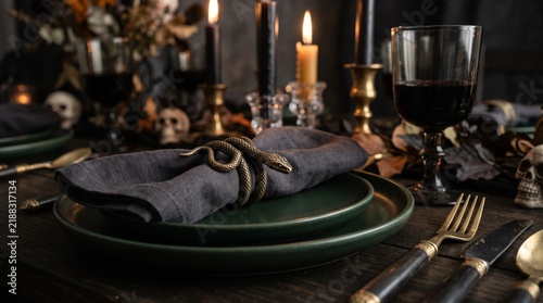 Gothic Halloween dinner table with snake napkin ring and skull decor