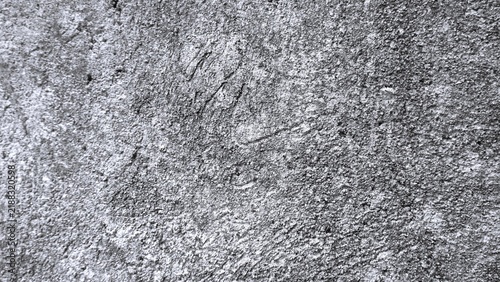 Obraz na płótnie Black and white distressed plaster wall texture with coarse grain and natural surface imperfections, creating an authentic grunge background