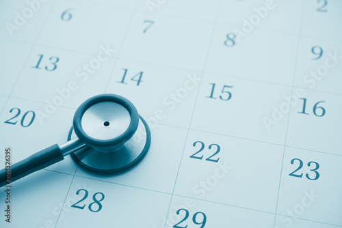 Stethoscope on white blank calendar background. Doctor appointment date reminder in hospital clinic center for health checkup, see condition and treatment. Healthcare, healthy lifestyle concept.