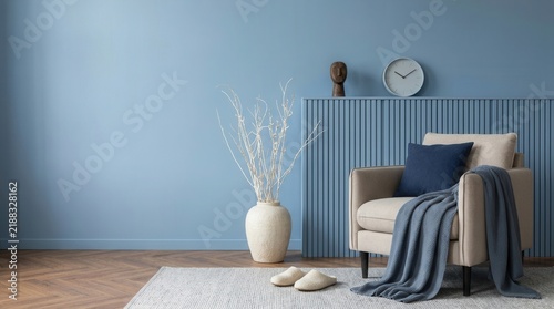 Contemporary interior with blue walls, natural light, and artistic decor.