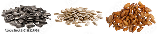 Three piles of sunflower seeds: raw striped, shelled white, and roasted brown, isolated on a white background.