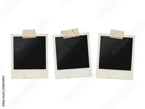 Obraz na plátně Three aged polaroid pictures secured with masking tape arranged in row on transparent backdrop