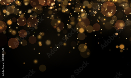 Fotografie Scattered golden bokeh orbs creating a soft glowing effect on a black background