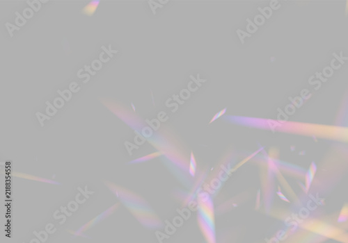 Irregular multicolored light shards scatter over a deep black background. These fractured beams exhibit a vibrant spectrum with blurred edges and soft gradients.