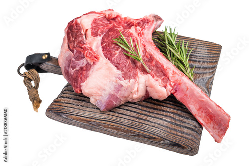 Fotografie Raw Tomahawk beef steak, fresh black angus ribeye with bone on wooden board Isolated on a white background