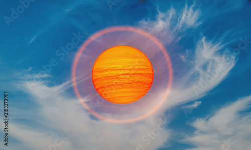 Stylized orange sun surrounded by a pink luminous ring against a vivid blue sky with wispy white clouds. Surreal celestial background with contrasting colors. Background with copy space