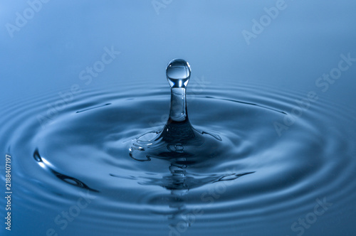 Waterdrop water droplet close-up in blue light.