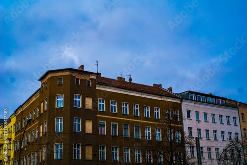 Apartment buildings under a cloudy sky