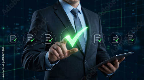 Businessman approving digital documents with a glowing green checkmark icon