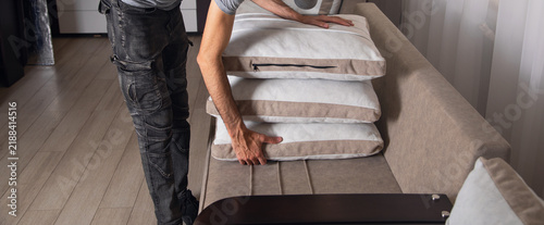 Obraz na płótnie Cleaning service worker prepare pillows for cleaning.