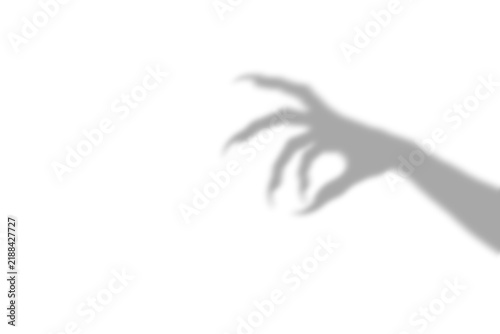 Принти на полотні A dark scary shadow of a clawed hand reaching out to grab something presented as