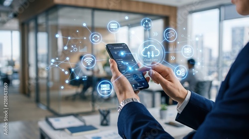 Business person using smartphone with holographic cloud data network interface icons floating around, mobile technology connectivity internet communication digital transformation