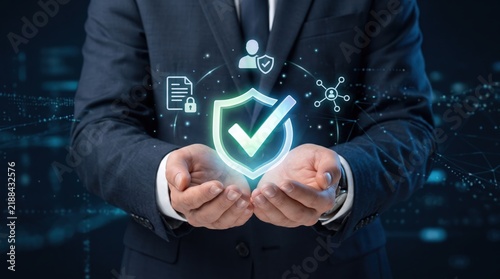 Businessman in suit holding glowing digital shield icon representing cybersecurity protection, data privacy verification and secure network technology concept background
