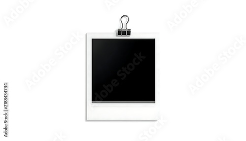 Blank instant photo frame white border black center clipped top black binder clip plain white background minimalist concept photography memory creative potential empty space