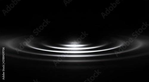 Concentric luminous circles emanate outward from a bright central point on a dark background
