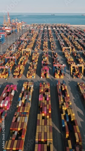 Aerial view of Valencia cargo sea port terminal with stacked colorful shipping containers and cranes pattern international logistics trade video stock