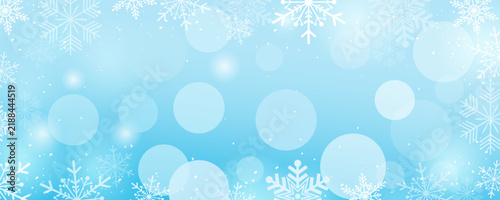 Blue winter background with beautiful snowflakes, snow, and light flares for design. Snowflake wallpaper with a frosted glass effect. Vector illustration of a Christmas banner.