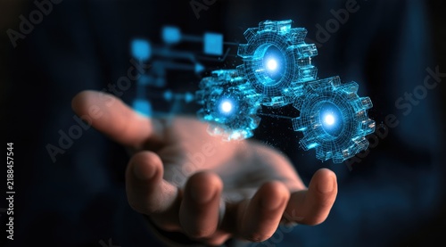 Glowing digital gears materialize over an outstretched hand, suggesting innovation