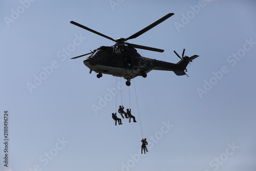 Armed special forces soldiers in camouflage tactical gear during a tactical combat exercise or combat operation