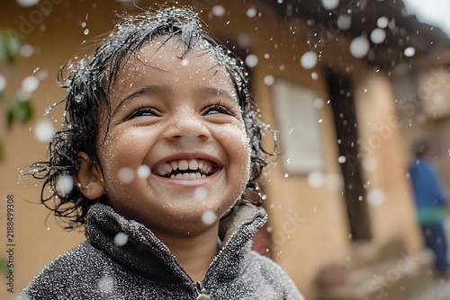 Happy child playing in the rain joyful expression.
