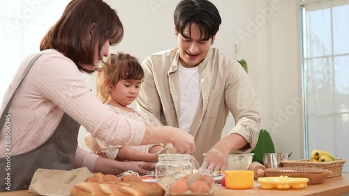 Family Enjoys Baking Together in a Bakery With a Girl Playing With Dough