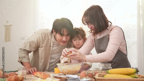 Family Enjoys Baking Together in a Bakery With a Girl Playing With Dough