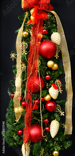Christmas decorations with spruce branches, red and gold ornaments and ribbons