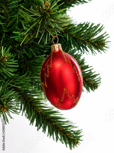 Red Christmas Ornament Hanging on Green Christmas Tree Branch