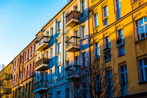 Row of colorful buildings with balconies in sunlight