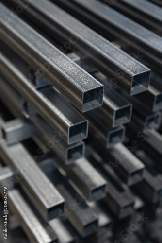Bundle of galvanised square steel profiles in a workshop