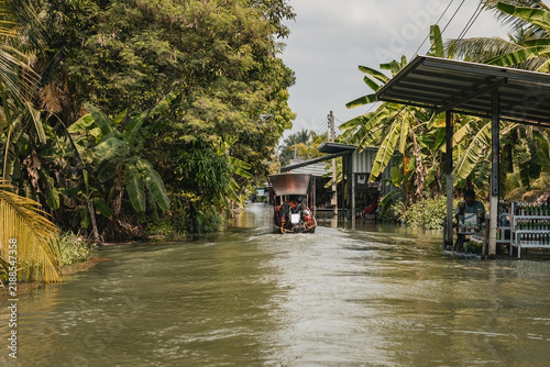 Traditional long boat on the cannal in Bangkok floating village Thailand