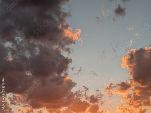 Photography Dramatic sunset clouds with orange golden light on dark storm clouds